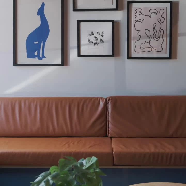 An orange leather sofa under framed art in a clinic lounge